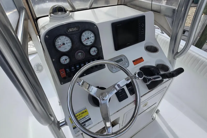 Slide: The Image of 2008 Sea Hunt Ultra 232 boat console with steering wheel and navigation equipment. - 10