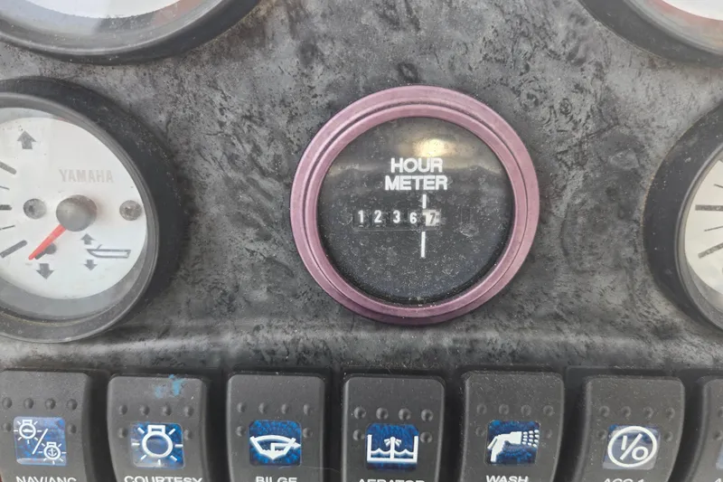 Slide: The Image of 2008 Sea Hunt Ultra 232 boat interior with storage compartment and portable toilet. - 14