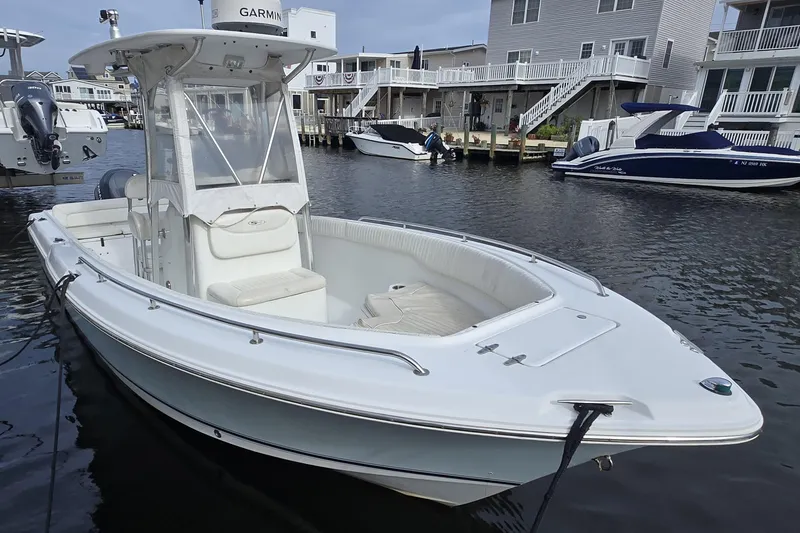 Slide: The Image of 2008 Sea Hunt Ultra 232 boat with Yamaha outboard motor docked on water. - 2