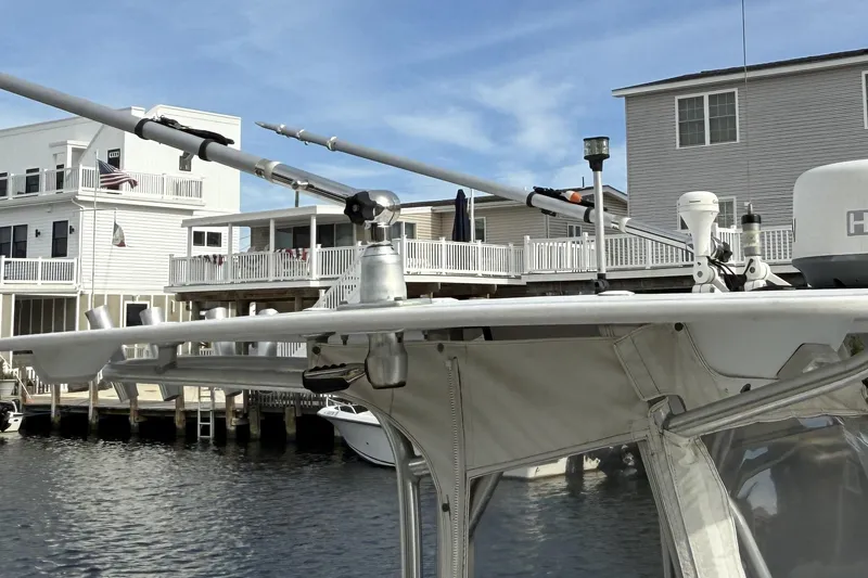 Slide: The Image of 2008 Sea Hunt Ultra 232 boat with spacious seating, docked on calm water. - 4