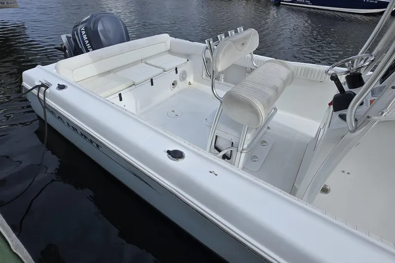 Slide: The Image of 2008 Sea Hunt Ultra 232 boat docked in a marina with waterfront homes. - 7