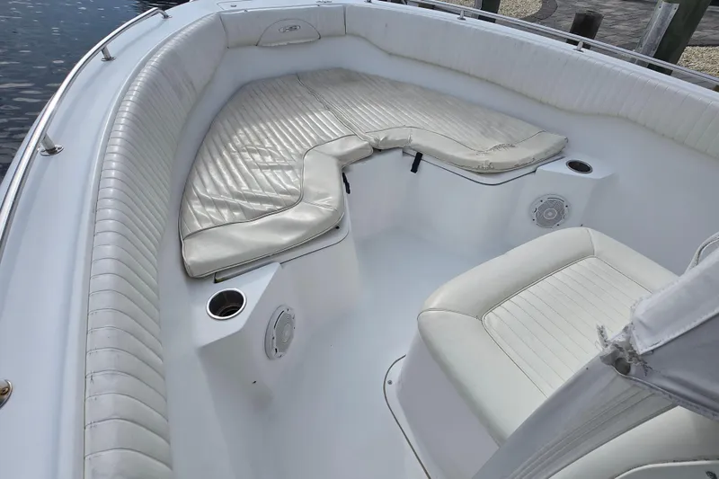 Slide: The Image of 2008 Sea Hunt Ultra 232 boat interior with seating and Yamaha engine, docked on water. - 8