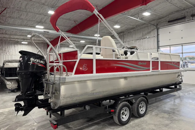 Slide: The Image of 2015 JC 241 Spirit TT Sport pontoon boat with Suzuki engine in a garage. - 3