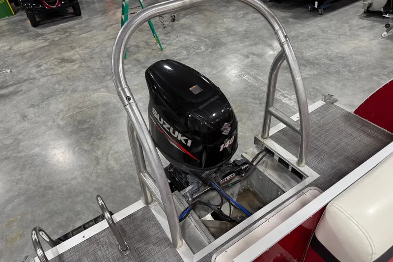 Slide: The Image of 2015 JC 241 Spirit TT Sport boat with Suzuki 140 outboard motor in a garage. - 7
