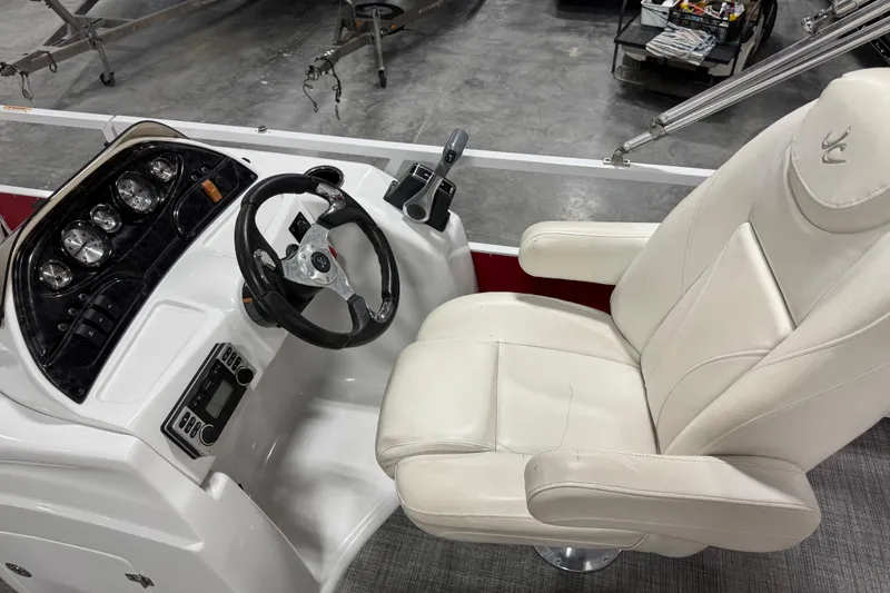 Slide: The Image of Cockpit of 2015 JC 241 Spirit TT Sport boat with steering wheel and white captain's chair. - 8