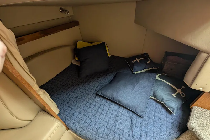 Slide: The Image of Cozy cabin interior of 2004 Cruisers Yachts 280 CXi Express with cushions and bedding. - 10