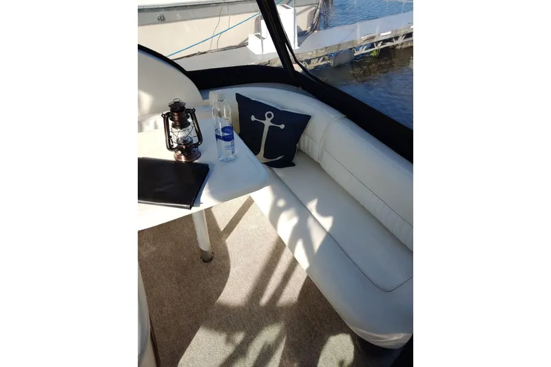 Slide: The Image of Interior of 2004 Cruisers Yachts 280 CXi Express with nautical decor and seating. - 4