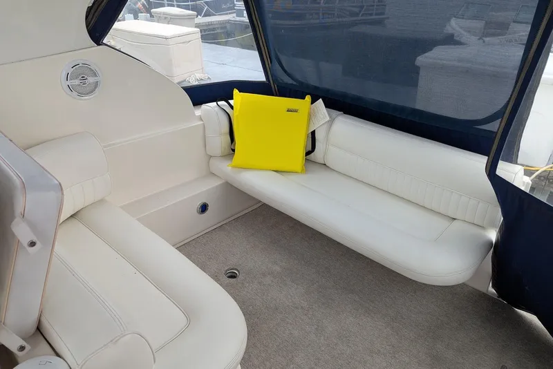 Slide: The Image of Interior of 2004 Cruisers Yachts 280 CXi Express with white seating and yellow cushion. - 2