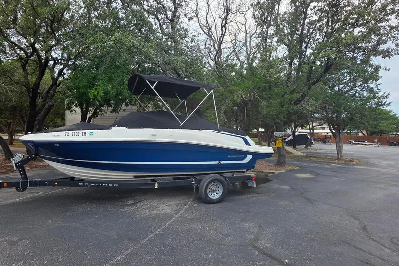 Slide: The Image of 2019 Bayliner VR4 Bowrider I/O on trailer, parked in a tree-lined area. - 19