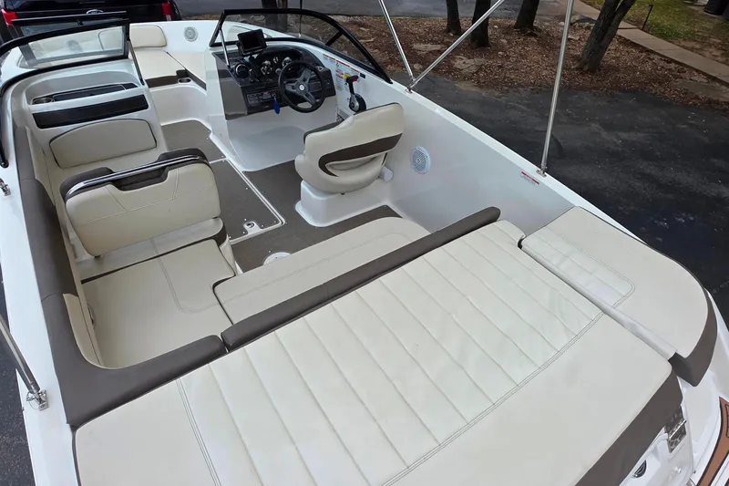 Slide: The Image of 2019 Bayliner VR4 Bowrider I/O interior with beige seating and modern dashboard. - 7
