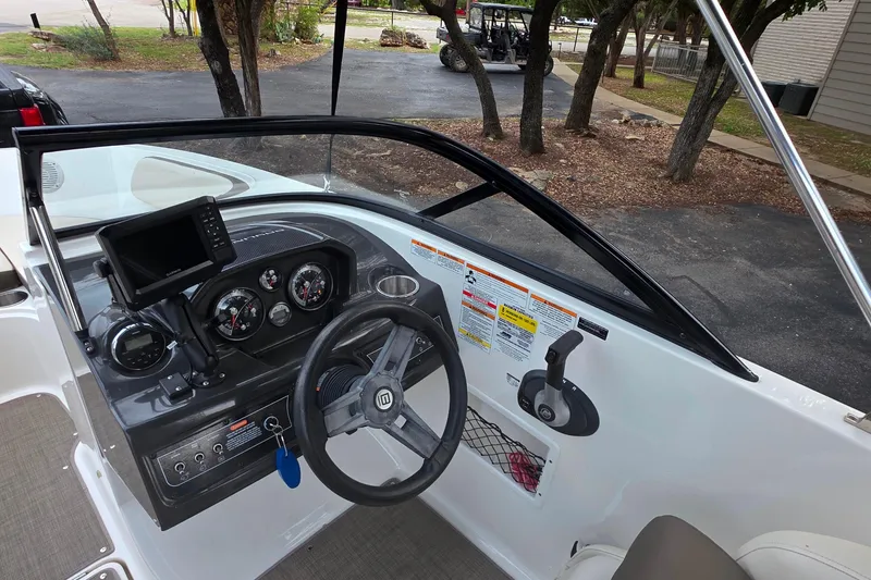 Slide: The Image of 2019 Bayliner VR4 Bowrider I/O dashboard with steering wheel and control panel. - 9