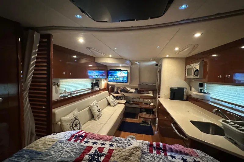 Slide: The Image of Luxurious interior of 2009 Sea Ray 350 Sundancer yacht with modern amenities and cozy seating. - 11