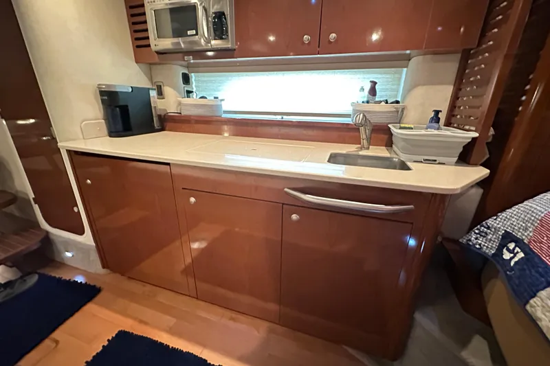 Slide: The Image of 2009 Sea Ray 350 Sundancer yacht interior kitchen with sink and microwave. - 6