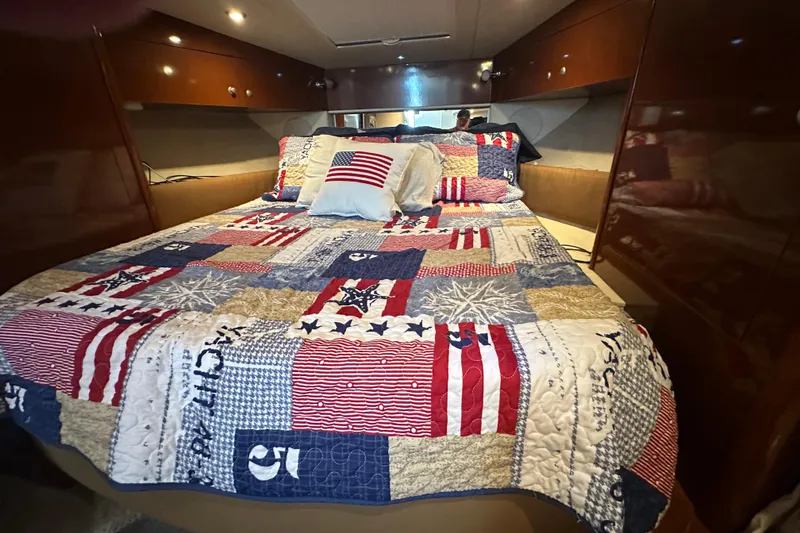 Slide: The Image of Cozy cabin interior of 2009 Sea Ray 350 Sundancer with patriotic quilted bedding. - 8