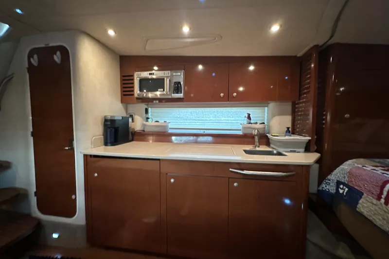 Slide: The Image of Luxurious 2009 Sea Ray 350 Sundancer yacht interior with modern kitchen amenities. - 9
