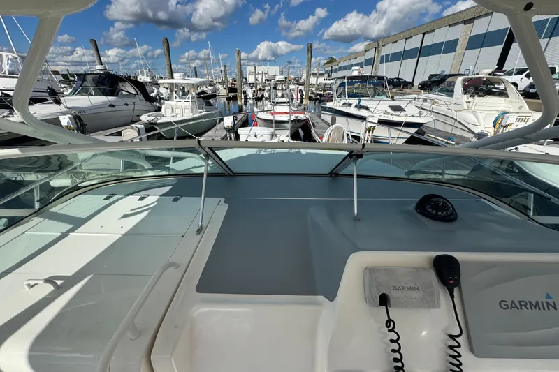 Slide: The Image of 2015 Wellcraft 290 Coastal boat docked at marina, clear sky, Garmin equipment visible. - 11