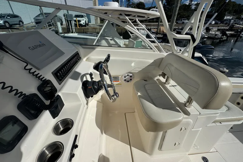 Slide: The Image of 2015 Wellcraft 290 Coastal boat cockpit with Garmin navigation and dual seating. - 12
