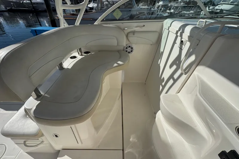 Slide: The Image of 2015 Wellcraft 290 Coastal boat interior with white seating and cup holders. - 13