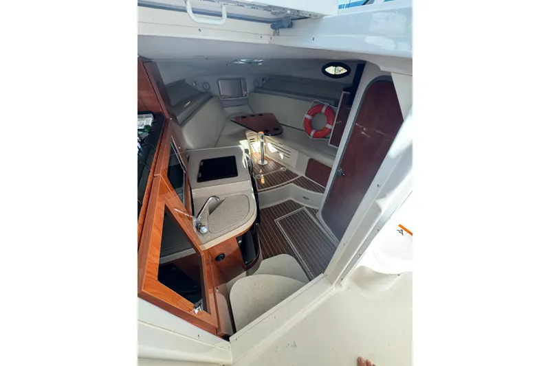 Slide: The Image of 2015 Wellcraft 290 Coastal cabin interior with kitchenette and seating area. - 18