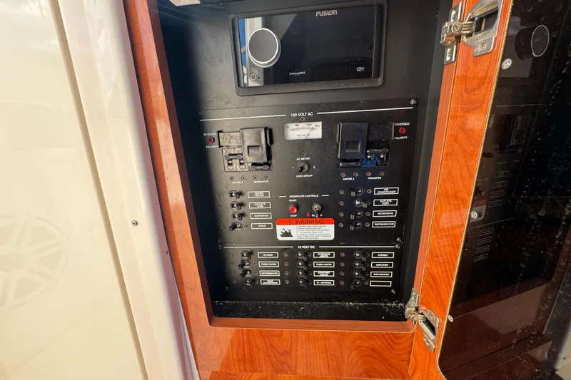 Slide: The Image of Electrical control panel on a 2015 Wellcraft 290 Coastal boat, featuring various switches and controls. - 19