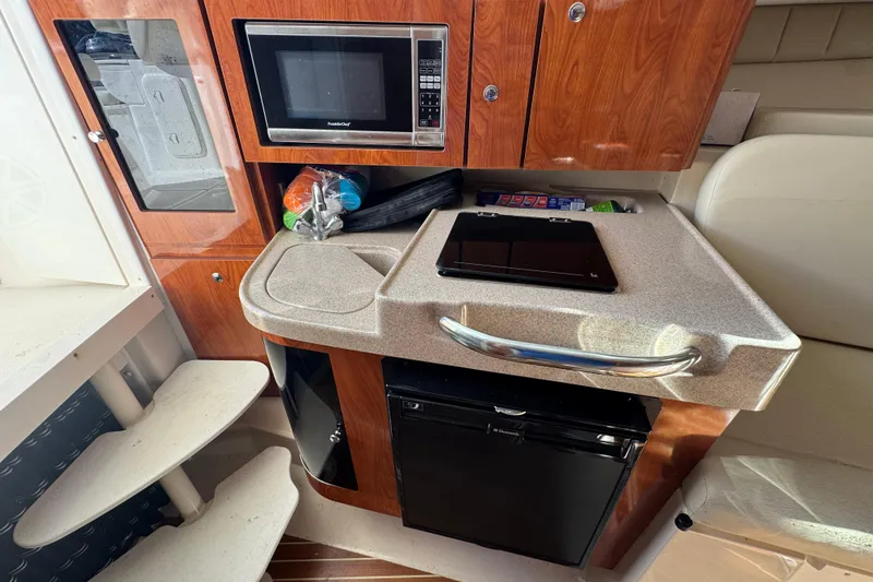 Slide: The Image of Compact kitchen area in 2015 Wellcraft 290 Coastal boat with microwave and fridge. - 20