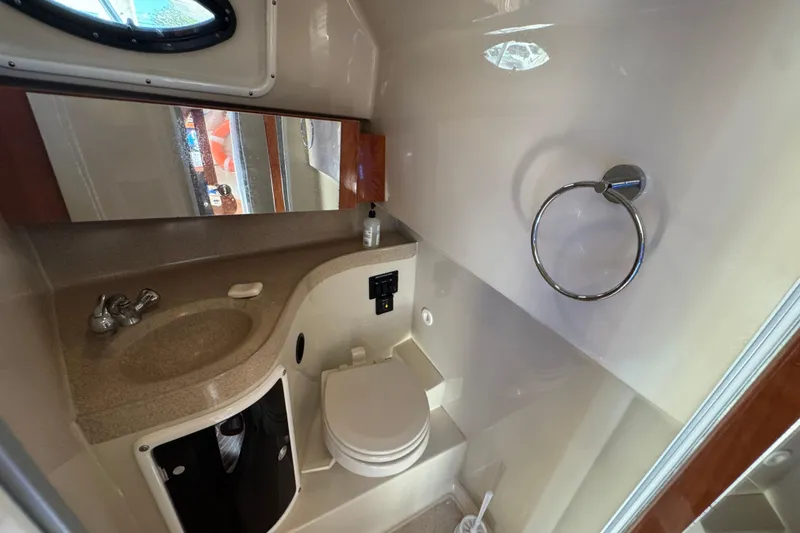 Slide: The Image of 2015 Wellcraft 290 Coastal boat bathroom with sink, toilet, and mirror. - 22