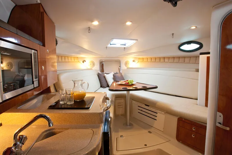 Slide: The Image of Manufacturer Provided Image: 2015 Wellcraft 290 Coastal cabin interior with kitchenette, dining area, and cozy seating. - 28
