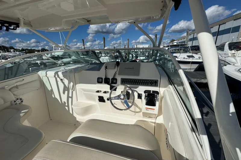Slide: The Image of 2015 Wellcraft 290 Coastal boat cockpit with steering wheel and control panel. - 9