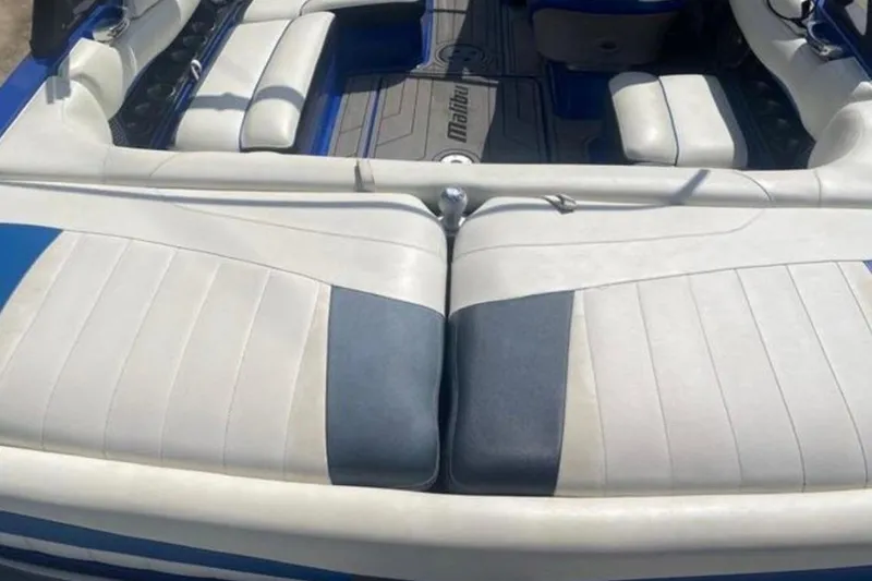 Slide: The Image of 2012 Malibu Wakesetter 22 MXZ interior with white and blue seating. - 10