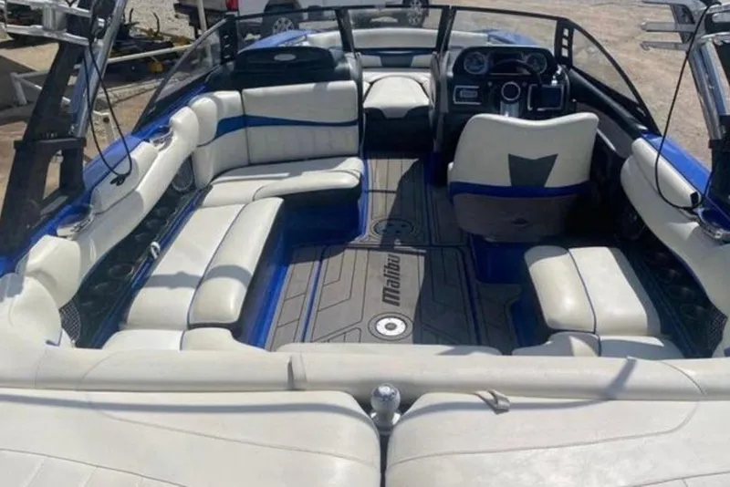Slide: The Image of 2012 Malibu Wakesetter 22 MXZ interior with spacious seating and modern dashboard. - 12