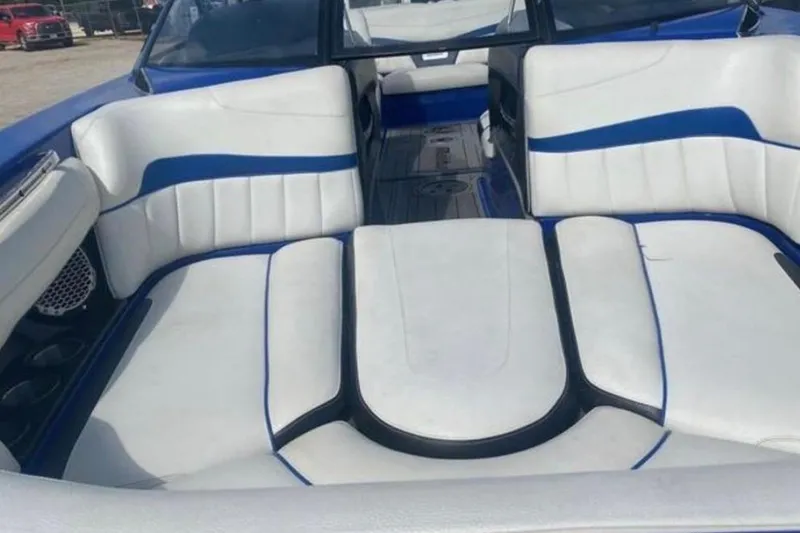 Slide: The Image of 2012 Malibu Wakesetter 22 MXZ boat interior with white and blue seating. - 6