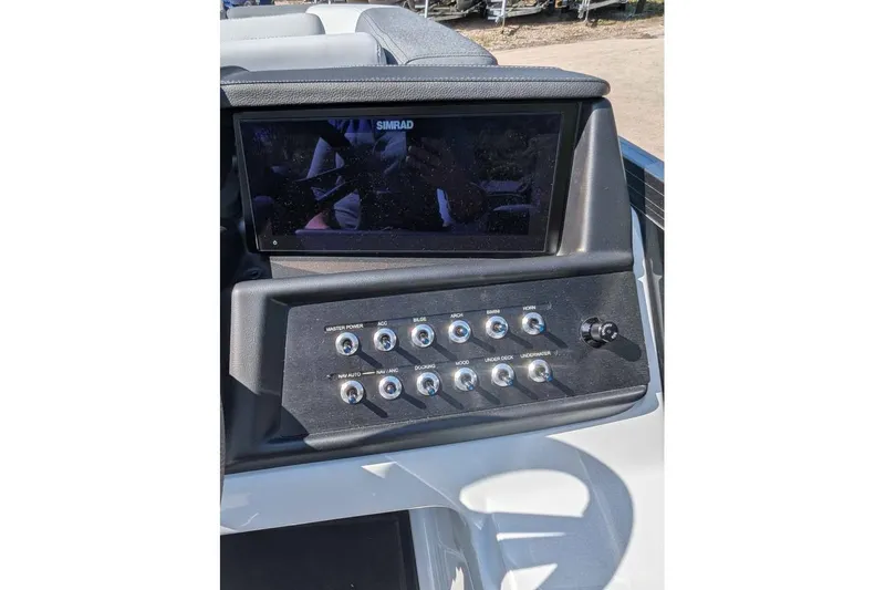Slide: The Image of Control panel of 2026 Alera M23Q boat with Simrad display and switches. - 11