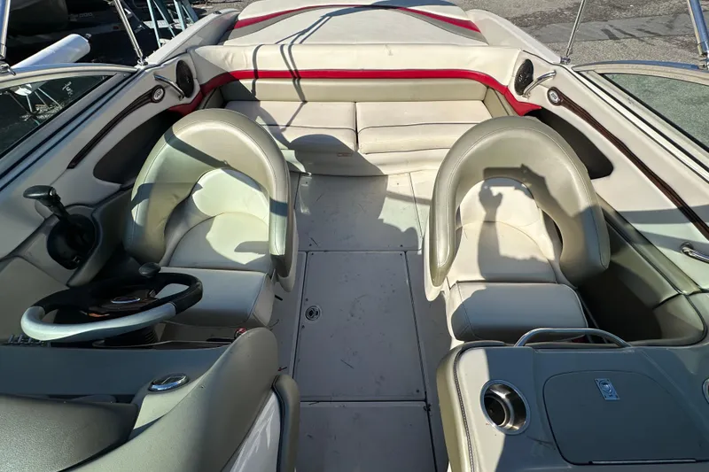 Slide: The Image of Interior of a 2005 Sea Ray 220 Select boat with seating and steering wheel. - 12