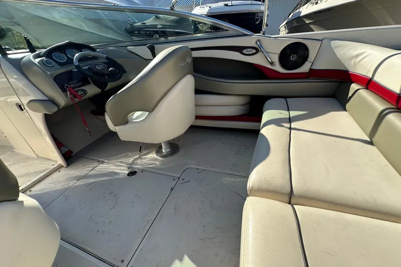 Slide: The Image of 2005 Sea Ray 220 Select boat interior with steering wheel and seating area. - 13