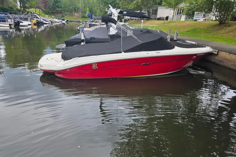 Slide: The Image of Red 2005 Sea Ray 220 Select boat docked with black cover in a marina. - 17