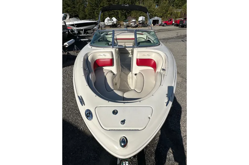 Slide: The Image of 2005 Sea Ray 220 Select boat with red and white interior, parked outdoors. - 5