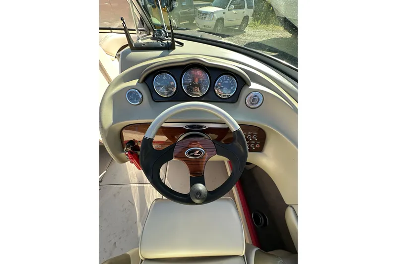 Slide: The Image of 2005 Sea Ray 220 Select boat dashboard with steering wheel and gauges. - 8