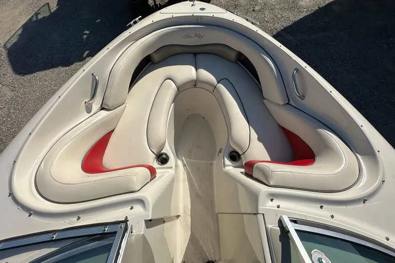 Slide: The Image of 2005 Sea Ray 220 Select boat interior with white and red cushioned seating. - 9