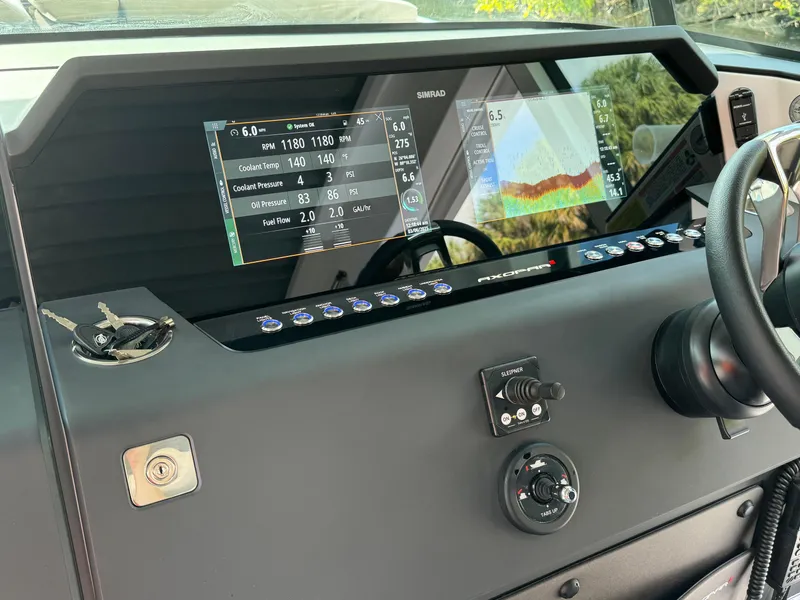 Slide: The Image of 2024 Axopar 37XC CROSS CABIN dashboard with navigation and control displays. - 13