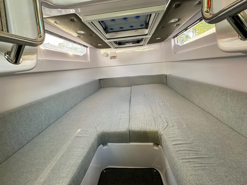 Slide: The Image of 2024 Axopar 37XC CROSS CABIN interior with spacious gray seating and overhead skylight. - 16