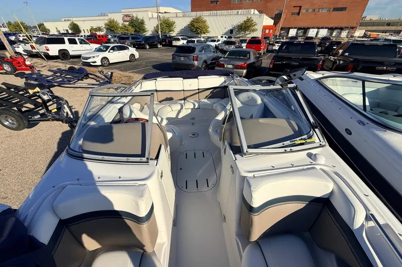 The Image of 2004 Four Winns 210 Horizon boat interior, parked in a busy lot. - 1