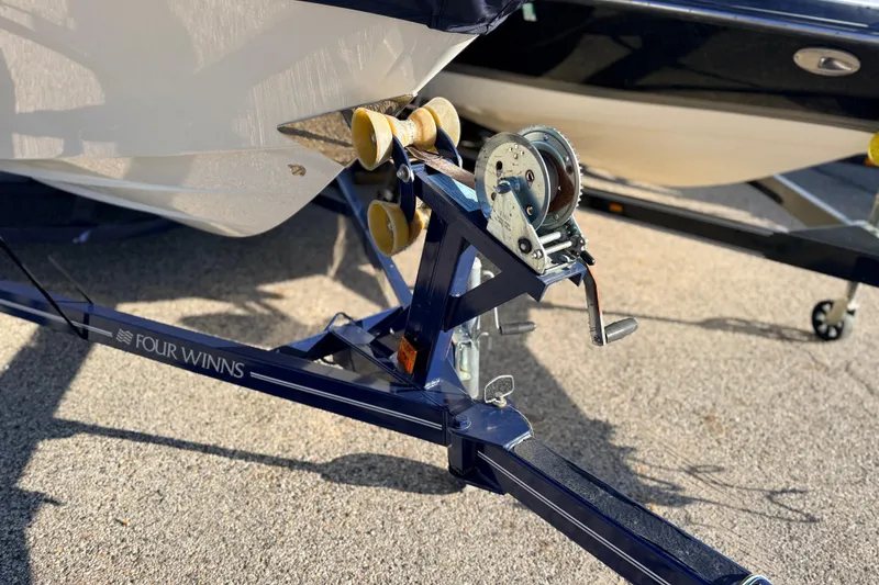 Slide: The Image of 2004 Four Winns 210 Horizon boat trailer with winch on a sunny day. - 13