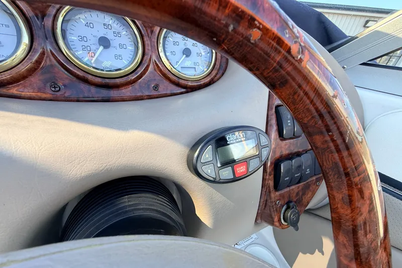 Slide: The Image of Dashboard of 2004 Four Winns 210 Horizon boat with wood trim and gauges. - 16