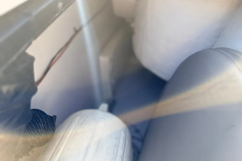 Slide: The Image of Interior view of a 2004 Four Winns 210 Horizon boat, showing seating and wiring. - 24