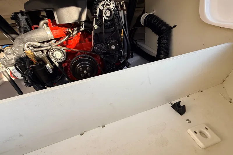 Slide: The Image of Engine compartment of a 2004 Four Winns 210 Horizon boat, showcasing mechanical components. - 26