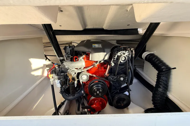 Slide: The Image of 2004 Four Winns 210 Horizon engine compartment with visible components and clean interior. - 27