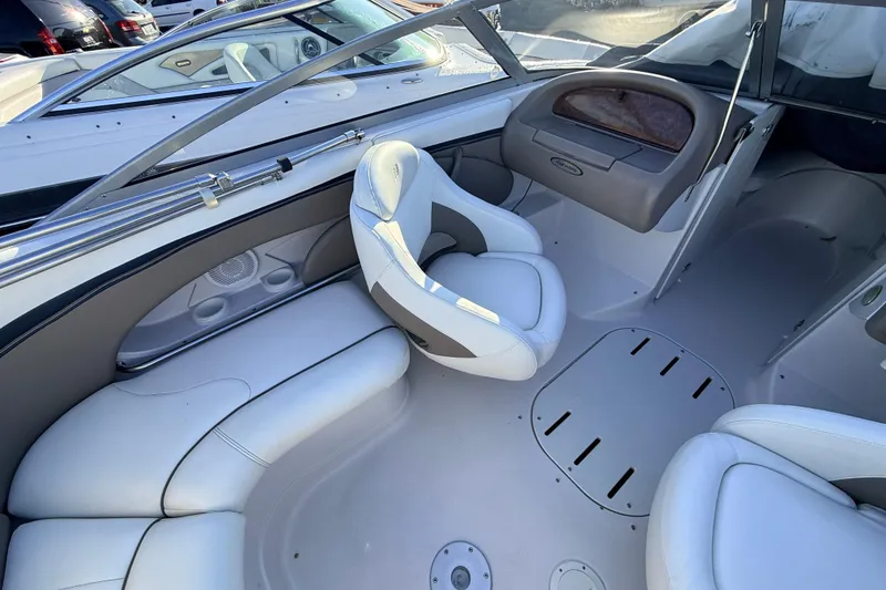 Slide: The Image of 2004 Four Winns 210 Horizon boat interior with white seating and dashboard. - 4