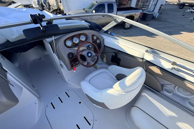 Slide: The Image of 2004 Four Winns 210 Horizon boat interior with steering wheel and dashboard controls. - 6