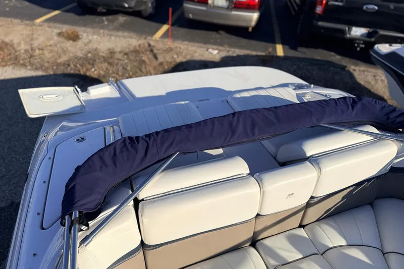 Slide: The Image of 2004 Four Winns 210 Horizon boat interior with white seating and navy cover. - 8