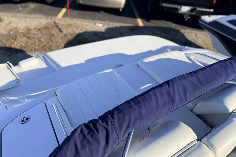 Slide: The Image of 2004 Four Winns 210 Horizon boat interior with white seating and blue cover. - 9